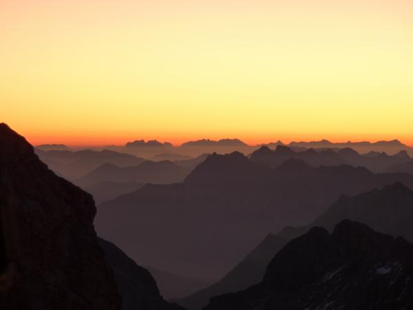 Silhouette of Hills Under Orange and Yellow Sky during Sunset