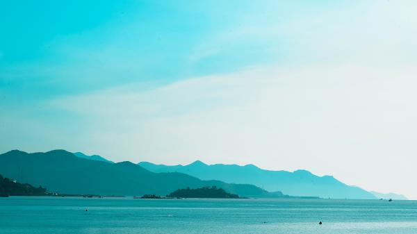 Silhouette of Mountain Near the Body of Water Photo in Daytime