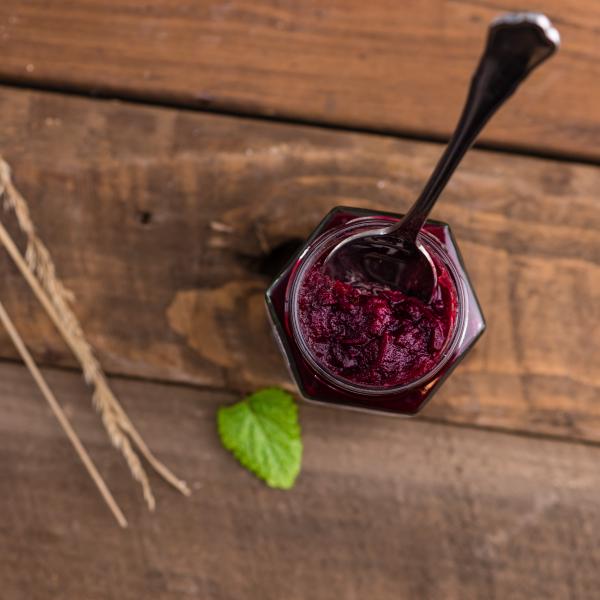 Silver Spoon on Red Syrup in Top View Photography