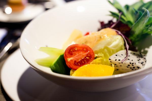 Sliced Tomatoes and Fruits on White Round Bowl