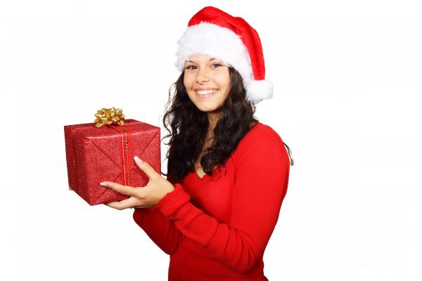 Smiling Woman in Red Long Sleeve Shirt Holding Red Gift Box