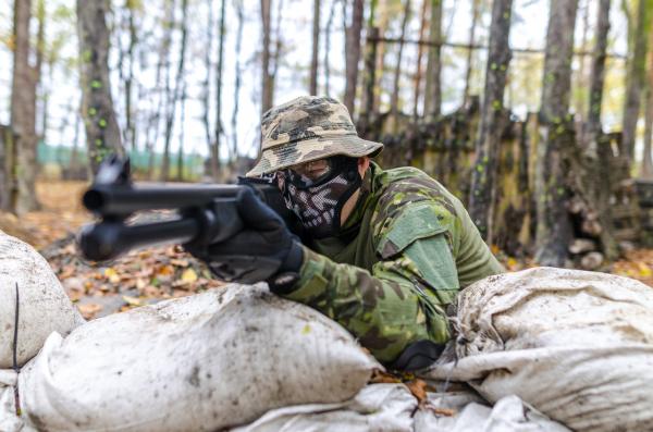 Soldier Holding a Rifle at Daytime