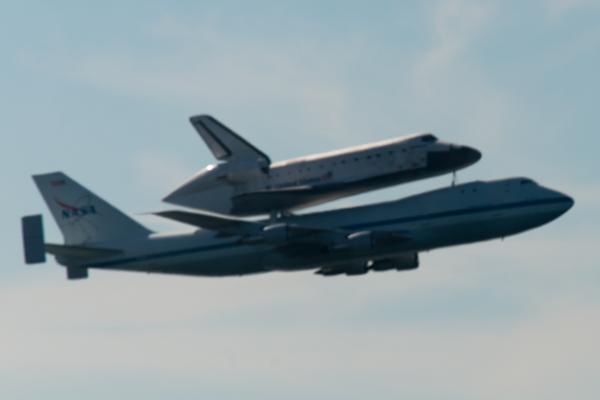 Space Shuttle Endeavour and carrier plane flying over San Francisco Bay - profile view
