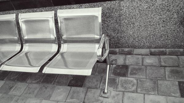Stainless Steel Bench on Top of Gray Pavement