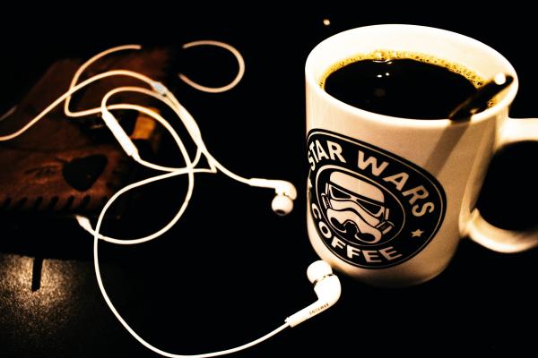 Star Wars Ceramic Mug Filled With Black Liquid With White Canal Buds Beside It