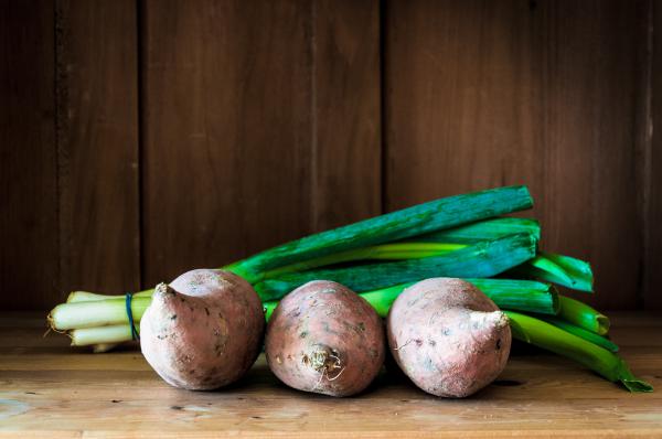 Sweet potatoes on wooden background