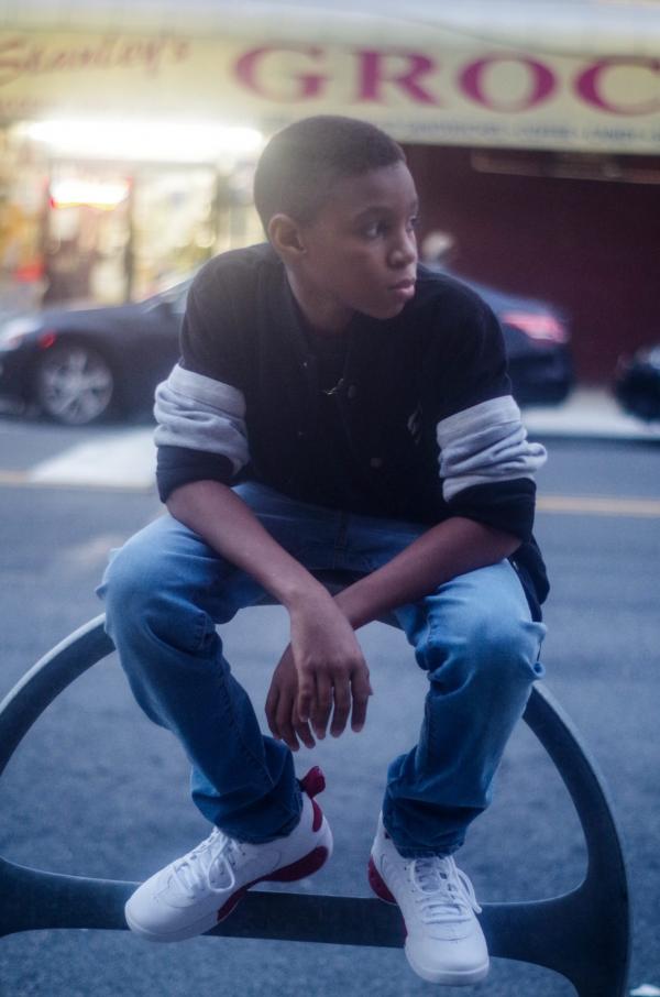 the child is sitting on the street