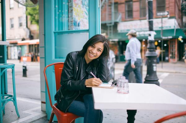 the girl writes at the table