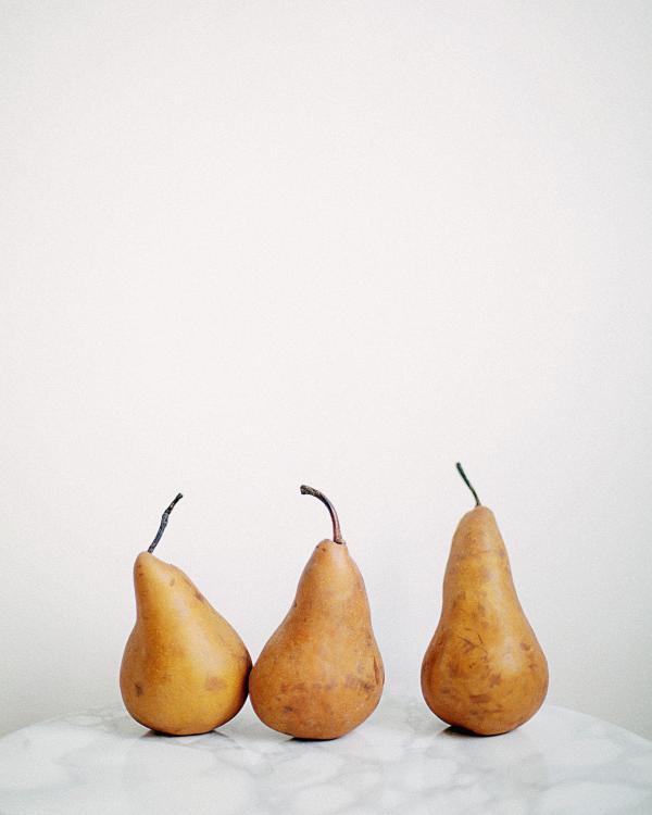 Three Brown Fruits on White Textile