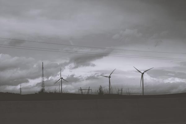 Three Wind Mills Under Cloudy Sky