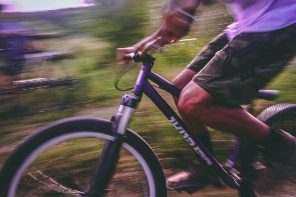Time Lapse Photo Of Man Riding On Bicycle
