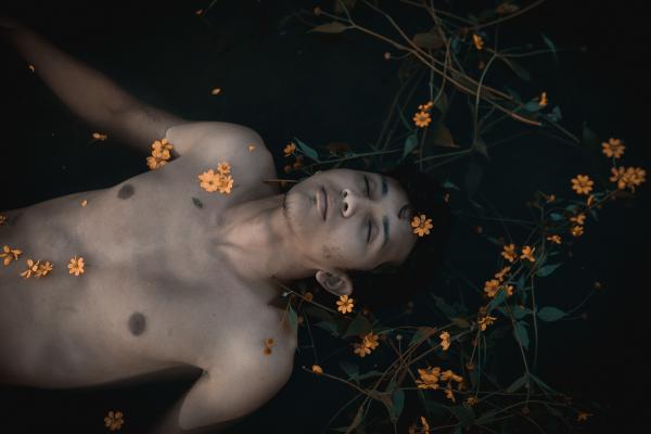 Topless Man With Orange Flowers