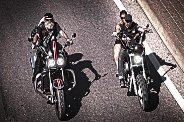 Two generations of bikers riding chopper