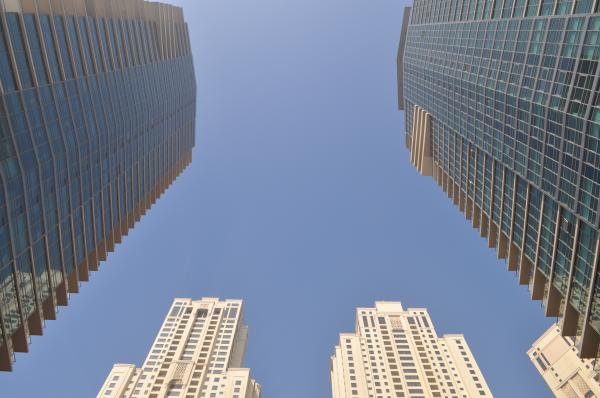 Two Gray-and-blue Glass Buildings