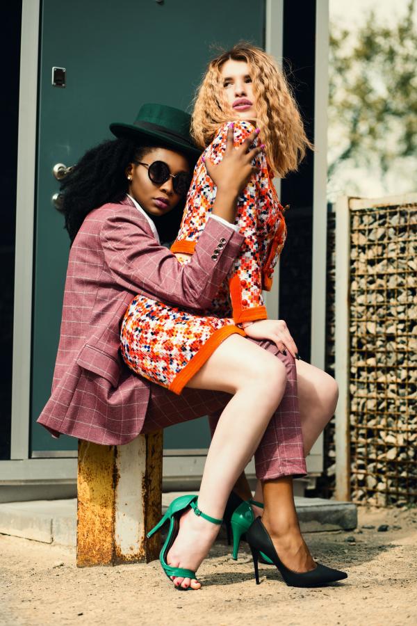 Two Ladies Sitting on Metal Bench