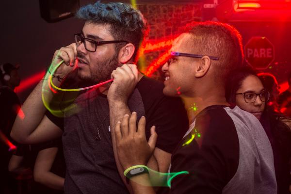 Two Man Wearing Eyeglasses Standing Under Red Led Light