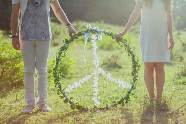 Two Person Holding White and Green Peace Wreath