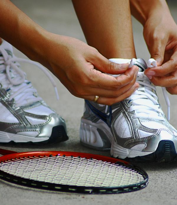Tying Shoe Laces Ready For A Game Of Badminton