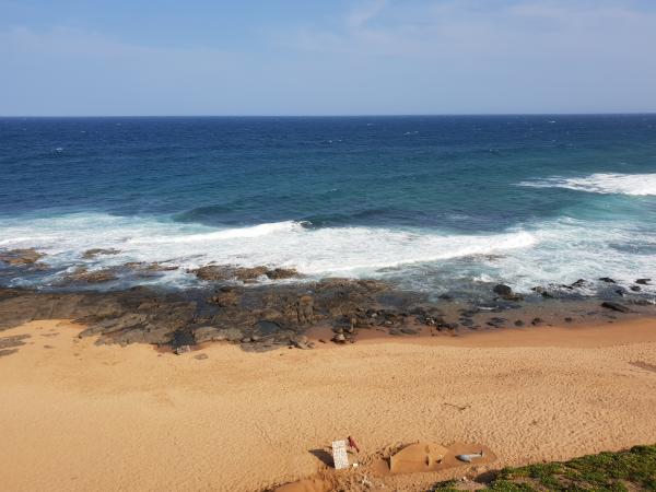 Waves crashing on the sandy beach