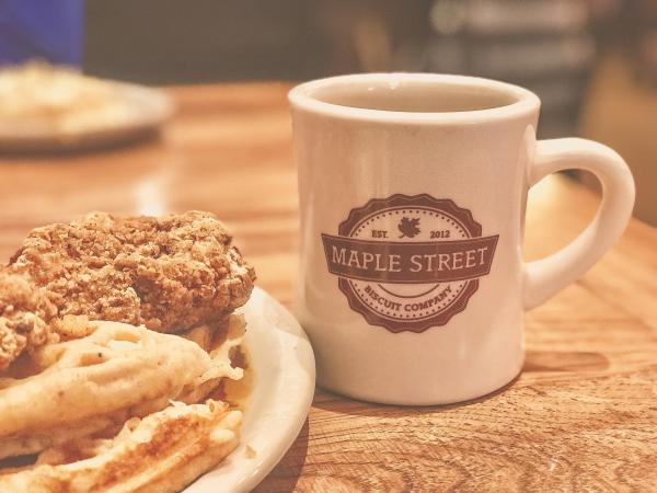 White and Brown Maple Street Ceramic Mug Beside Food