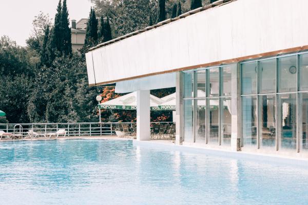 White and Gray Concrete Building Near Blue Swimming Pool