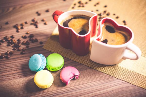 White and Red Couple Heart Mug Filled With Coffee And Macaroons