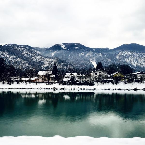White Houses in Front of Mountains Under White Cloudy Sky
