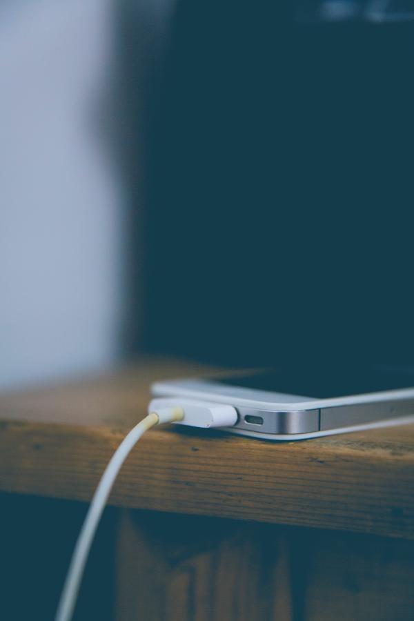 White Iphone 4 at Top of Brown Table
