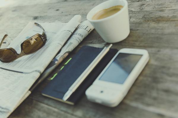 White Phone Near Black Note With Coffee