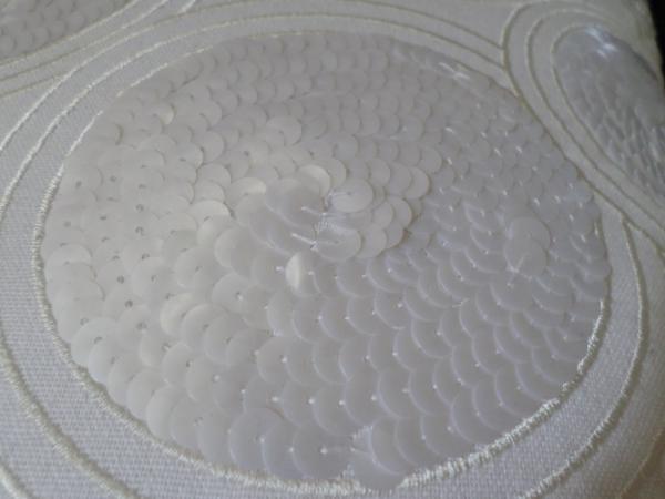 White sequins on fabric
