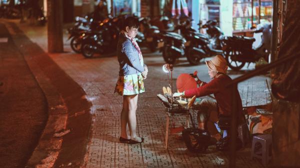 Woman buying from a street vendor