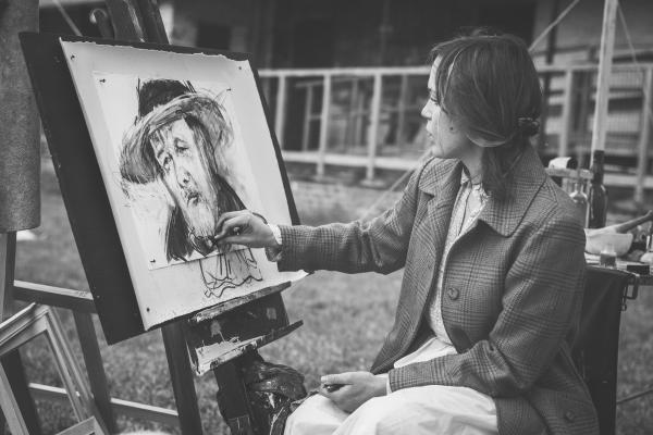 Woman Drawing a Man With Hat