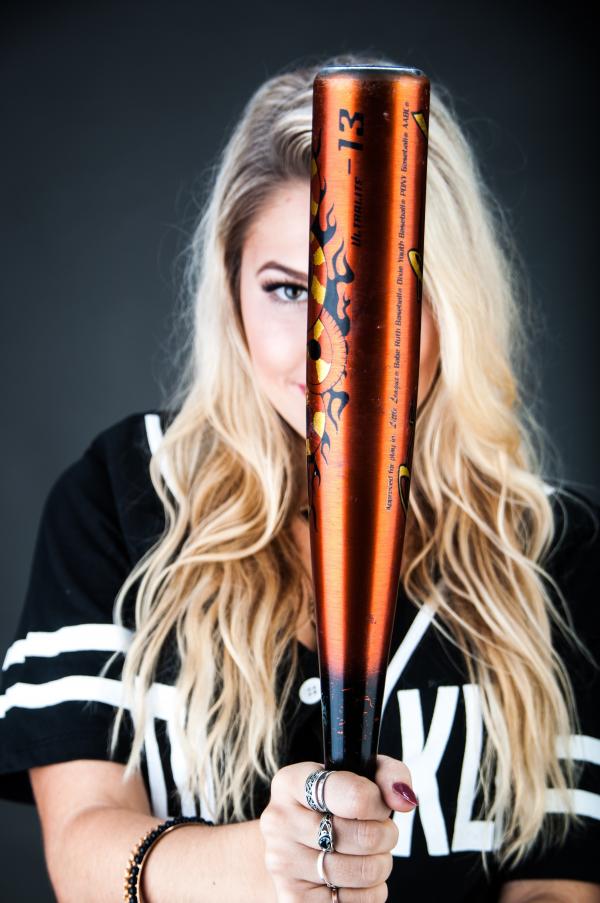Woman Holding Brown and Black Baseball Bat