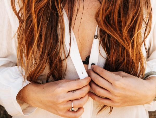 Woman Holding Buttons of Clothes