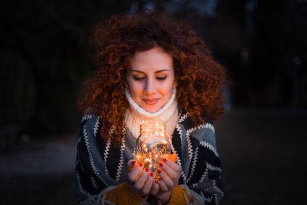 Woman Holding Clear Glass Jar Filled With Lights