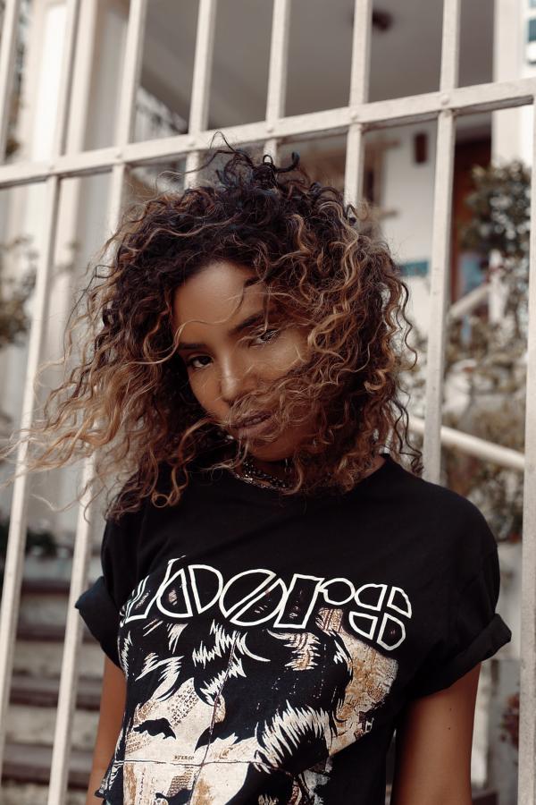 Woman in Black and White Crew-neck Shirt Posing for Photo