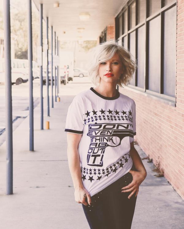 Woman in Black and White Crew-neck T-shirt Standing on Gray Floor