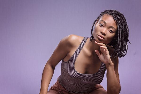 Woman in Black and White Tank Top Posing for Picture