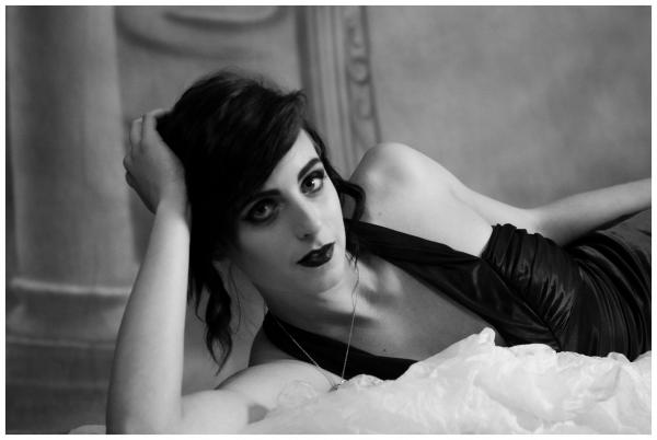 Woman in Black Top Lying on Bed
