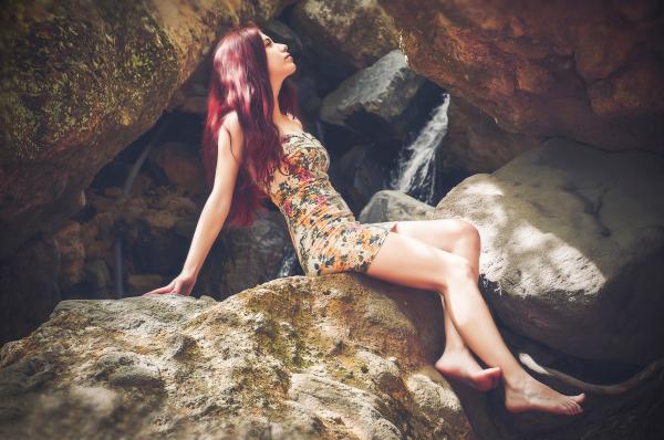 Woman in Bodycon Mini Dress Sitting on Boulder