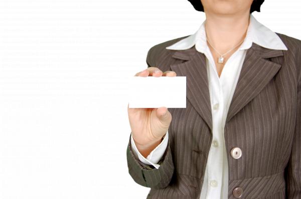 Woman in Brown Stripe Blazer Holding White Card