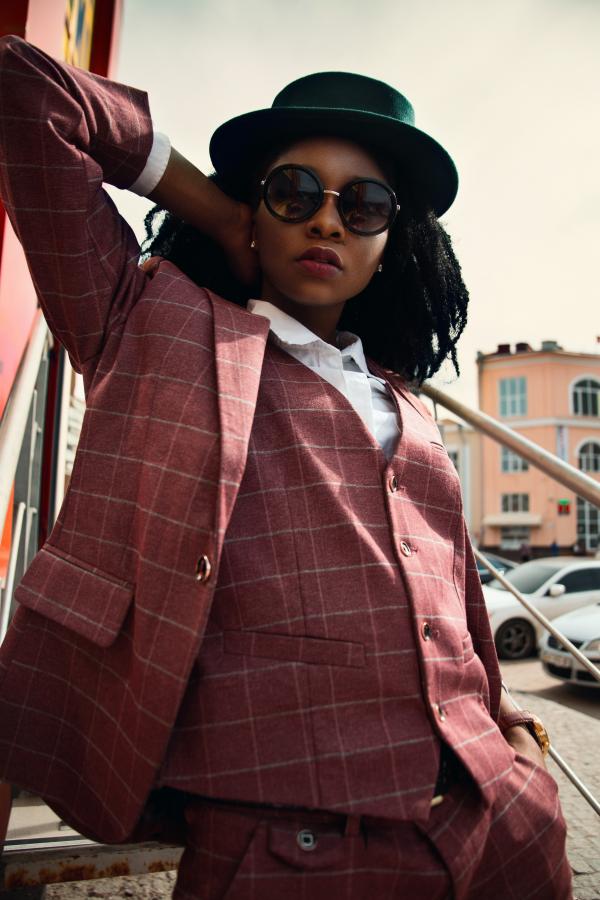 Woman in Maroon Buttoned Coat Wearing Black Hat