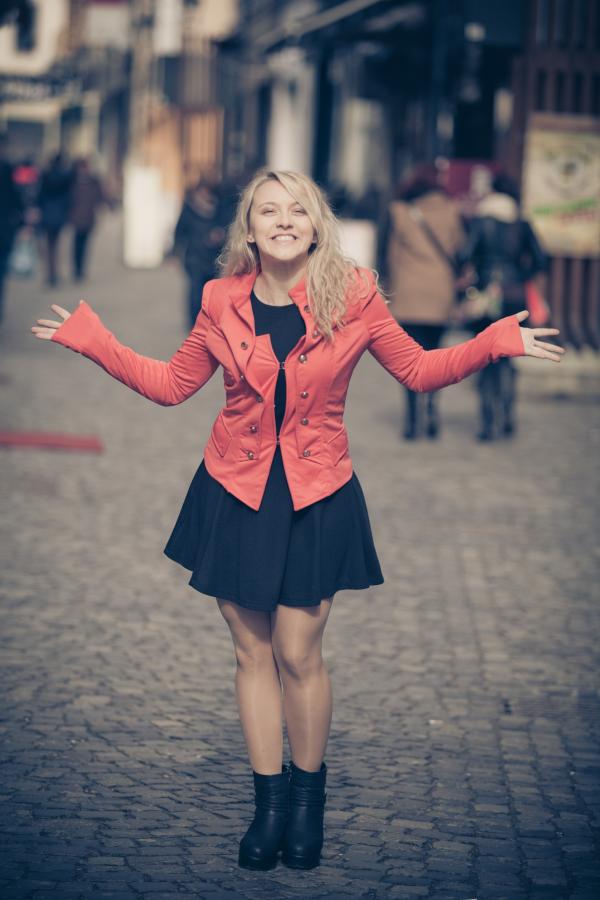 Woman in Red Jacket and Black Skirt