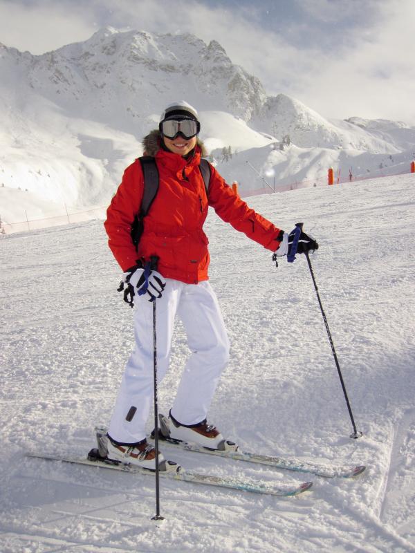 Woman in Red Jacket and White Pants on White Snow