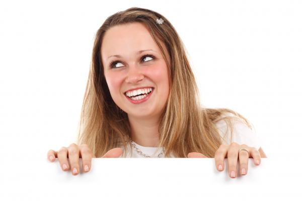 Woman in White Crew Neck Shirt Behind White Wall