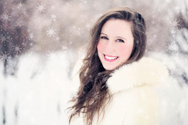 Woman in White Furred Jacket Smiling in Front