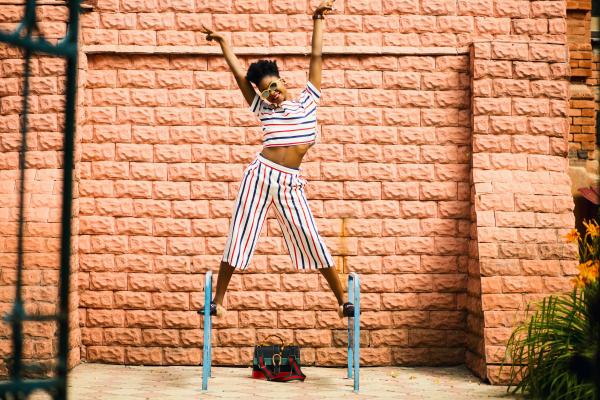Woman in White-red-and-blue Striped Pants and Top