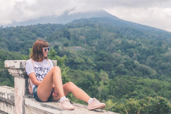 Woman in White Shirt and Blue Denim Short Shorts Sitting