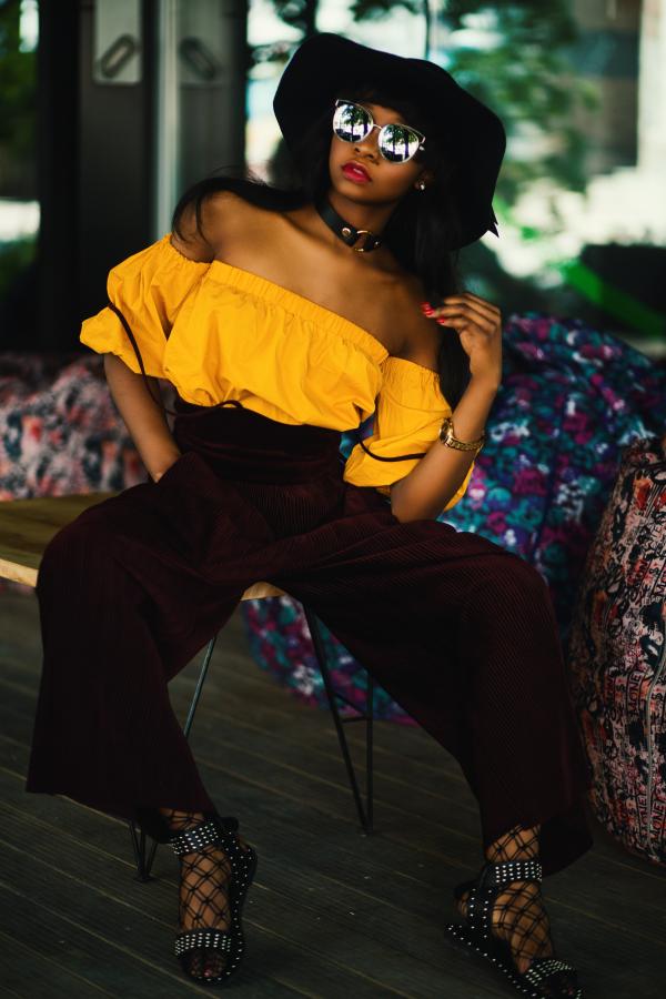 Woman in White Tube Top and Brown Pants