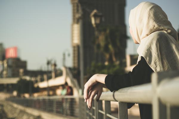Woman Leaning on Hand Rails